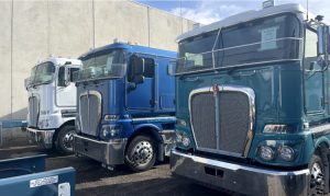 Semi-trucks parked in a row, representing trusted truck movers Australia with real-time GPS tracking.